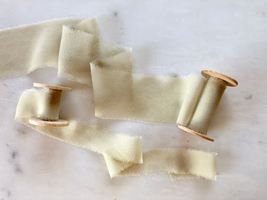 Sage green silk chiffon ribbon. Hand dyed and handmade with a frayed edge, available on a wooden spool.