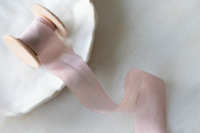 dusty rose pink handmade silk ribbon on a wooden spool